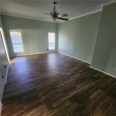 a view of a house with a yard and potted plants