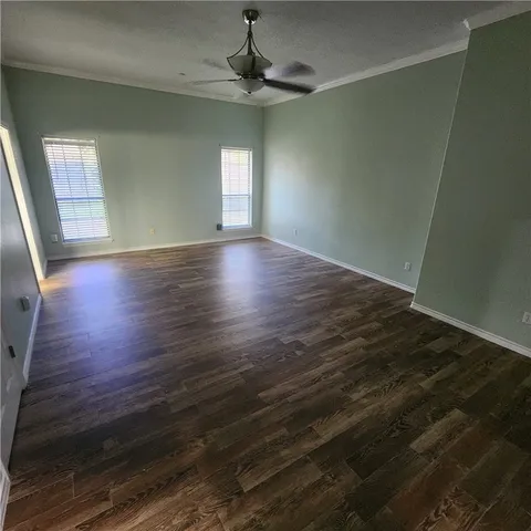 a view of a house with a yard and potted plants