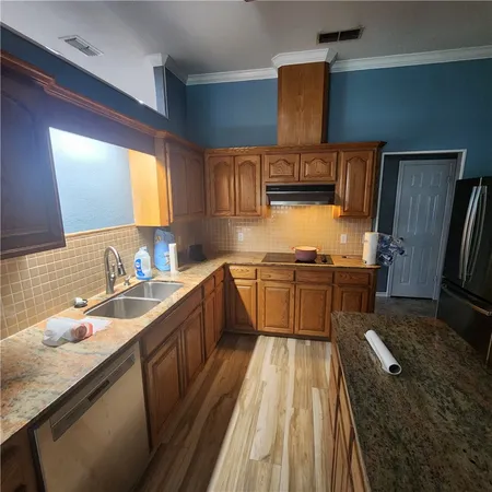 a kitchen with a sink stove and refrigerator