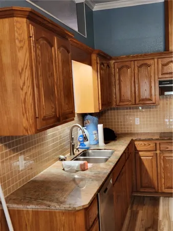 a kitchen with sink a window and appliances