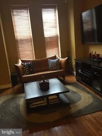 a living room with a couch and a flat screen tv