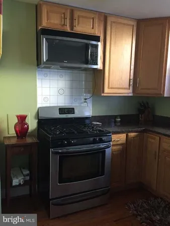 a stove top oven sitting inside of a kitchen
