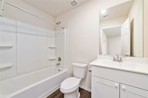 a bathroom with a sink toilet vanity and shower