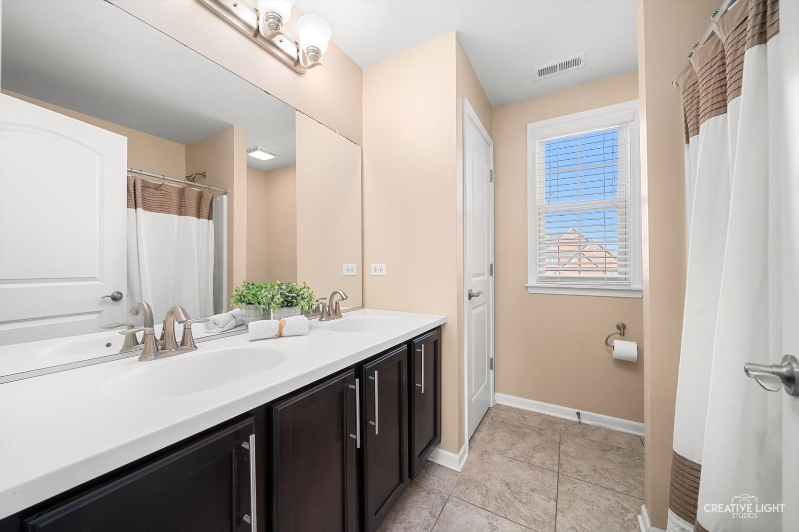 5332 Cedar Drive Naperville, IL 60564 - Photo 28 of 56 a bathroom with a sink double vanity and a mirror