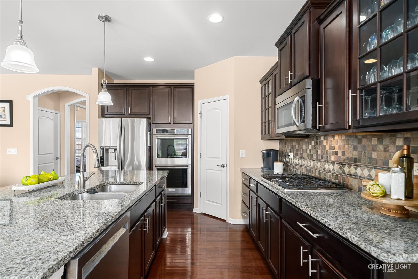 5332 Cedar Drive Naperville, IL 60564 - Photo 3 of 56 a kitchen with stainless steel appliances granite countertop a sink a stove and a wooden cabinets