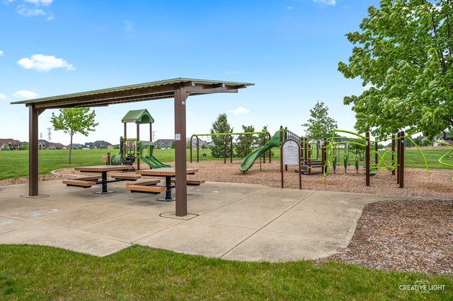 5332 Cedar Drive Naperville, IL 60564 - Photo 49 of 56 a backyard of a house with table and chairs