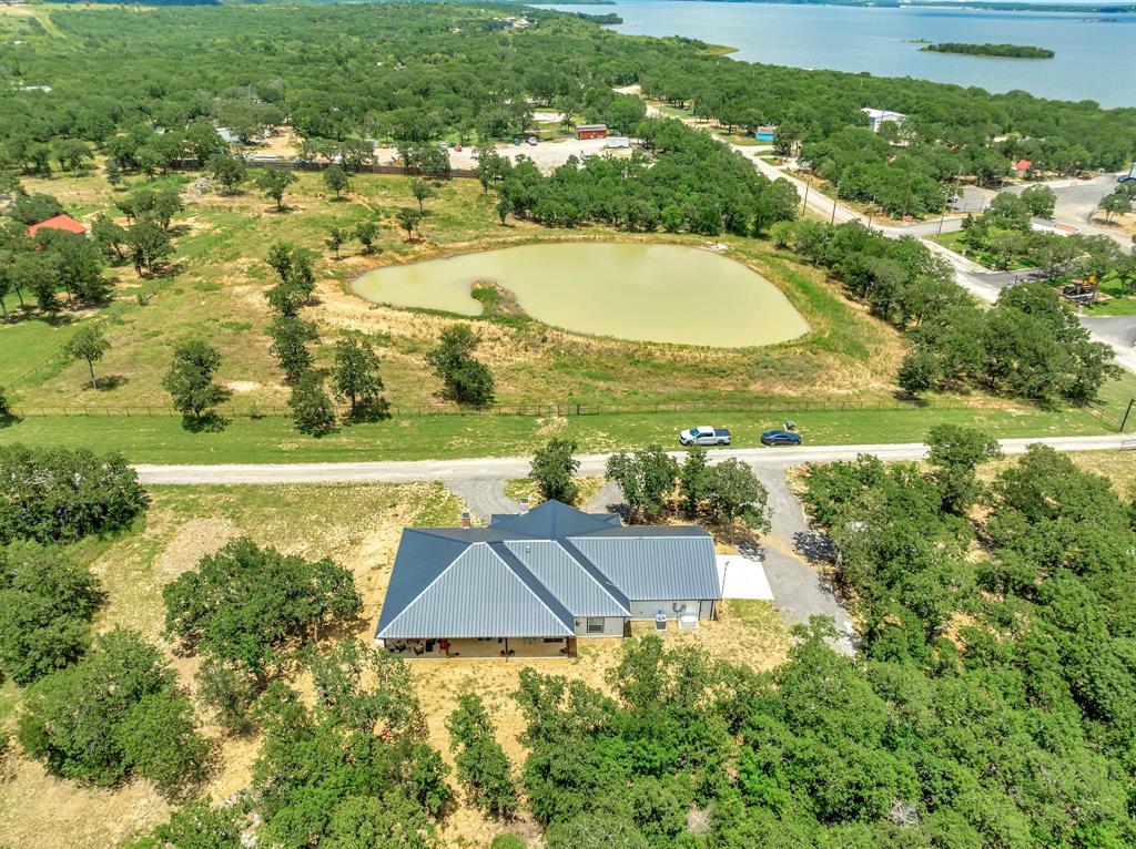 129 Whiskey Rnch Road Runaway Bay, TX 76426 - Photo 36 of 39 an aerial view of residential houses with outdoor space and swimming pool