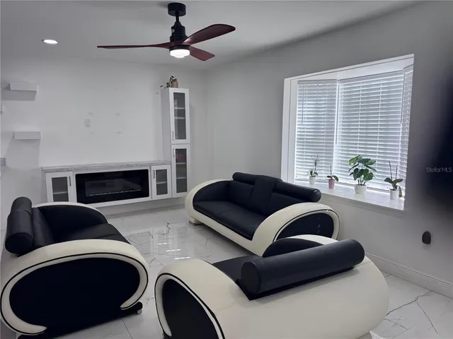 a large kitchen with stainless steel appliances kitchen island granite countertop a refrigerator and a sink