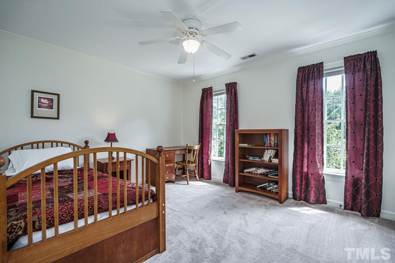 8601 Zinfandel Place Raleigh, NC 27615 - Photo 18 of 29 a bedroom with furniture and a large window