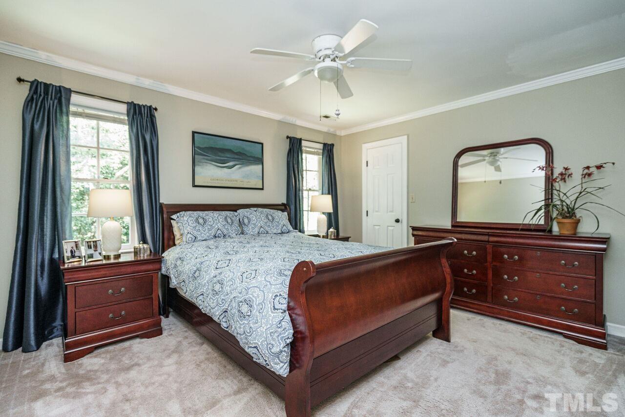 8601 Zinfandel Place Raleigh, NC 27615 - Photo 19 of 29 a bed room with a bed and a dresser