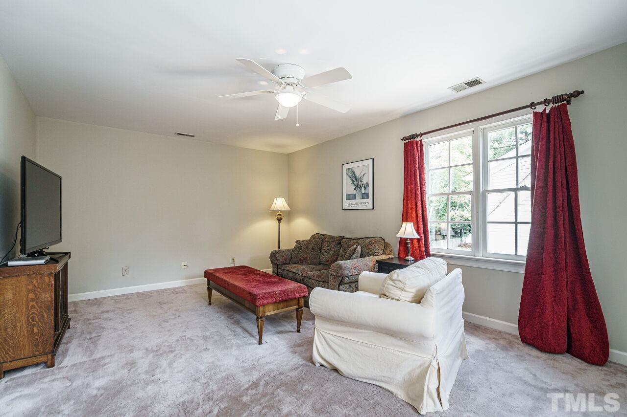 8601 Zinfandel Place Raleigh, NC 27615 - Photo 20 of 29 a living room with furniture and a flat screen tv