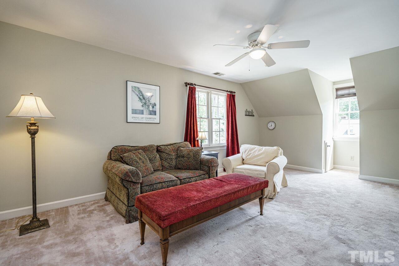 8601 Zinfandel Place Raleigh, NC 27615 - Photo 21 of 29 a living room with furniture and a chandelier