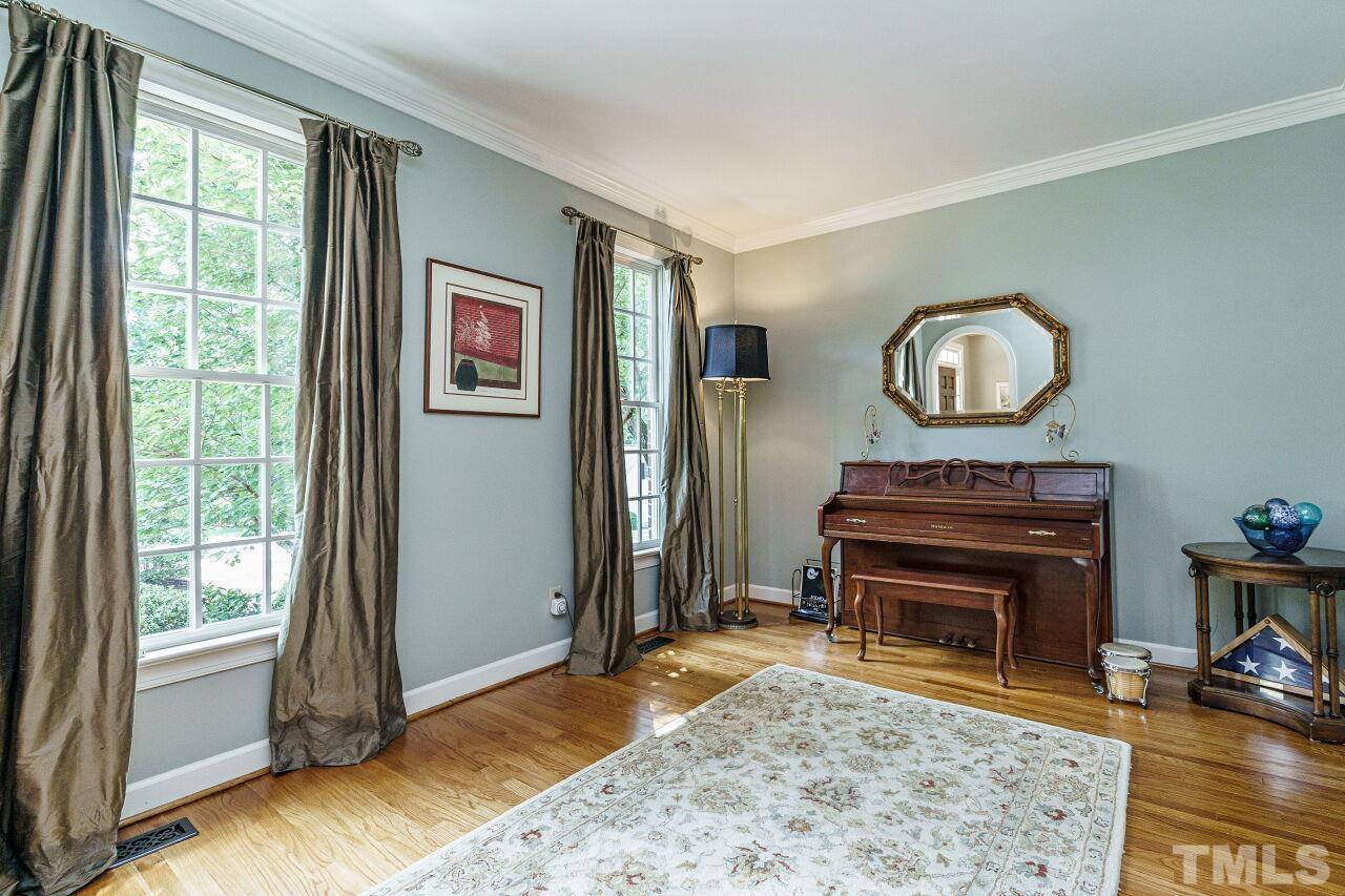 8601 Zinfandel Place Raleigh, NC 27615 - Photo 4 of 29 a living room with furniture a piano and a window