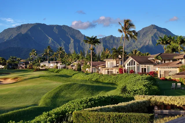 a front view of a house with a yard and a garden