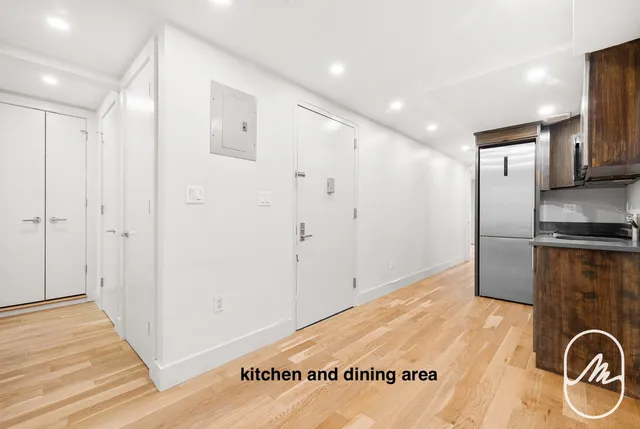 a view of a refrigerator in kitchen and wooden floor
