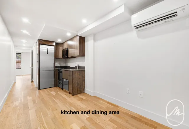 a kitchen with granite countertop a refrigerator stove top oven and sink