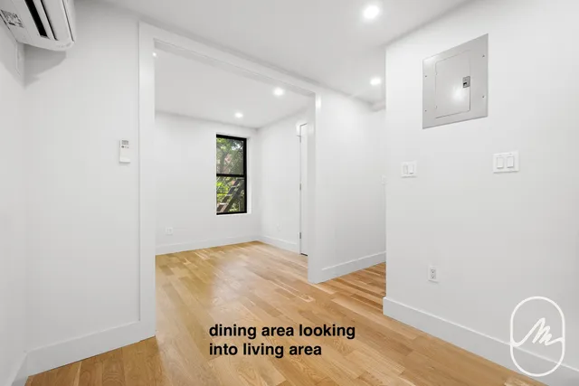 a view of a hallway to a room with windows