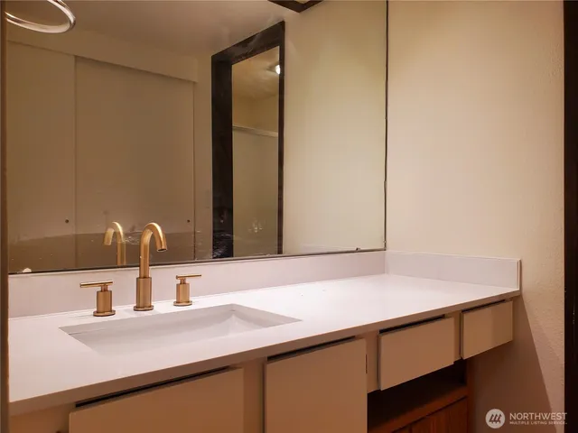 a bathroom with a sink and a mirror