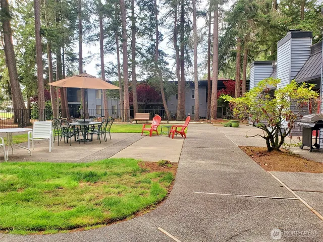 a view of a backyard with sitting area