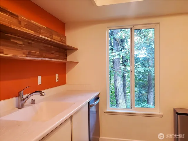 a bathroom with a sink and a window