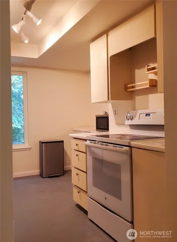 a kitchen with a stove and a microwave
