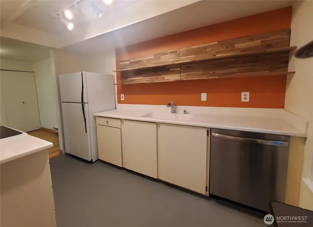 a kitchen with a sink and cabinets