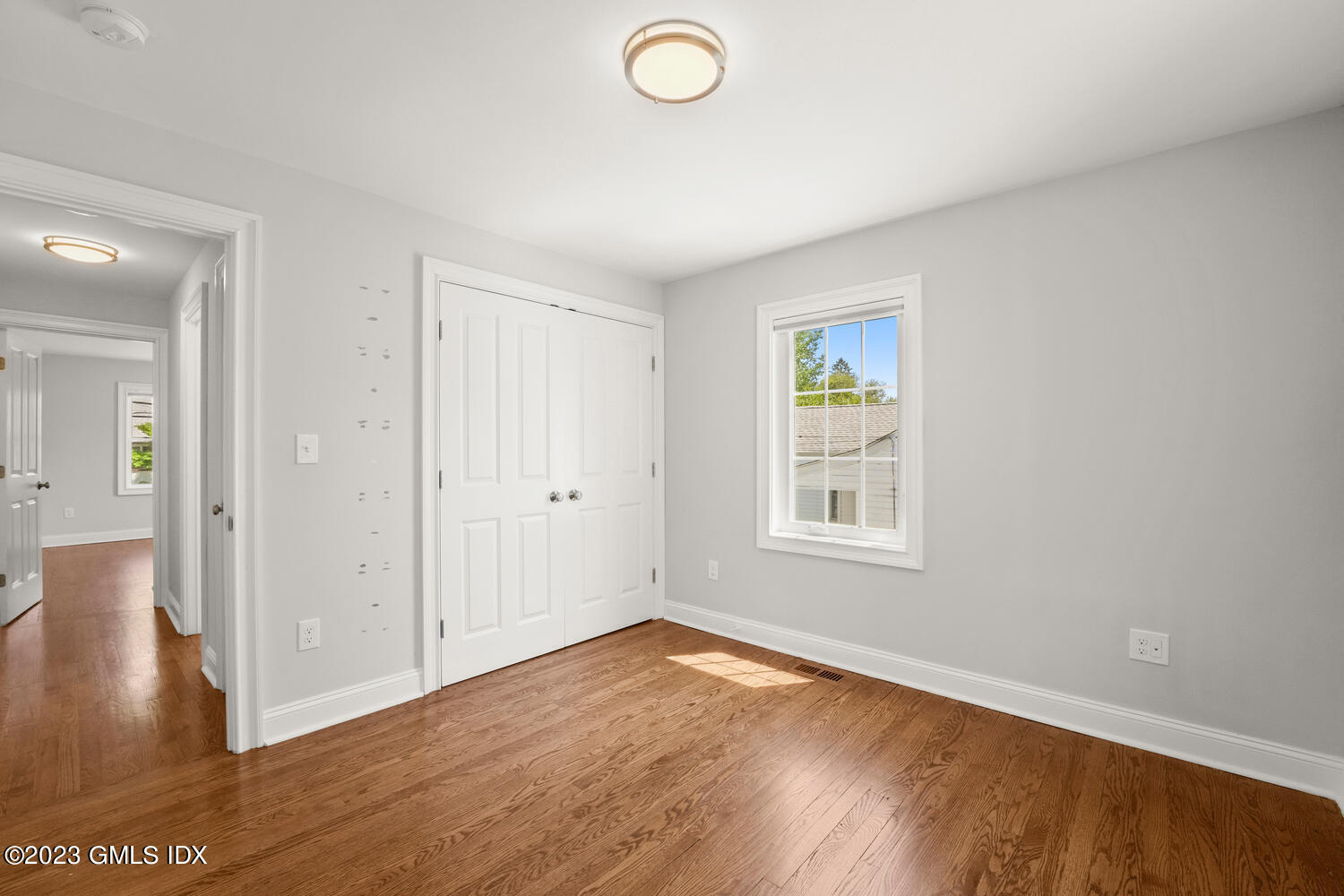 36 Sheep Hill Road Riverside, CT 06878 - Photo 14 of 37 an empty room with wooden floor and windows