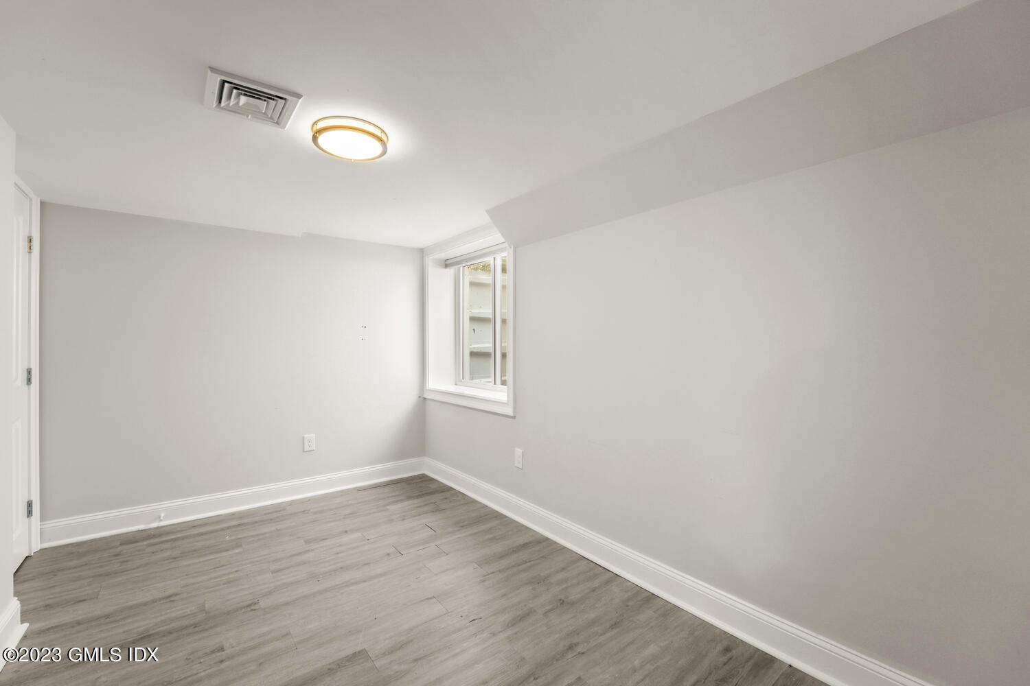36 Sheep Hill Road Riverside, CT 06878 - Photo 25 of 37 an empty room with wooden floor and windows