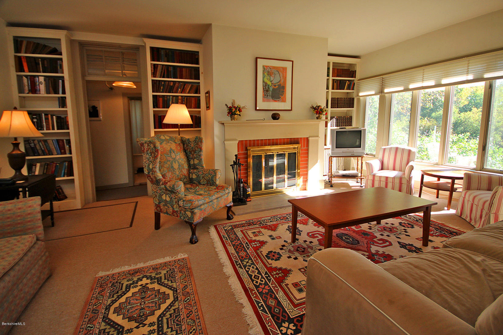 20 Main Street Stockbridge, MA 01262 - Photo 27 of 40 a living room with furniture a rug and a bookshelf