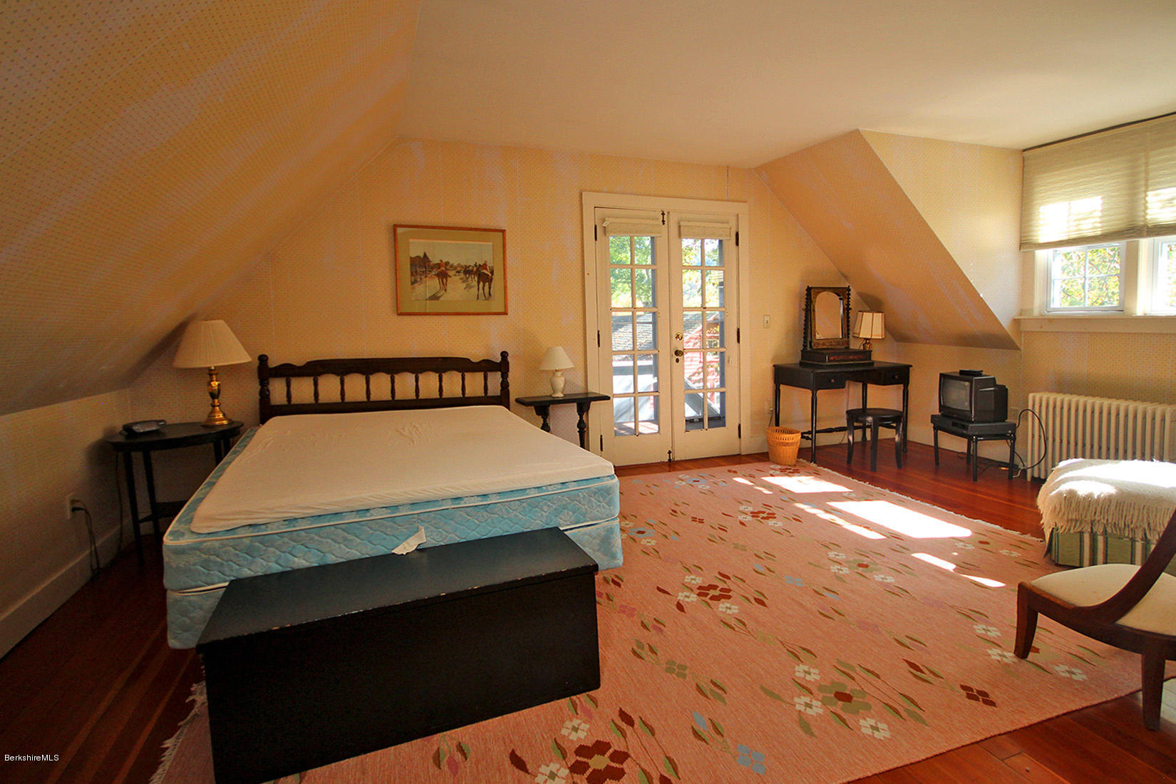 20 Main Street Stockbridge, MA 01262 - Photo 34 of 40 a spacious bedroom with a bed and wooden floor