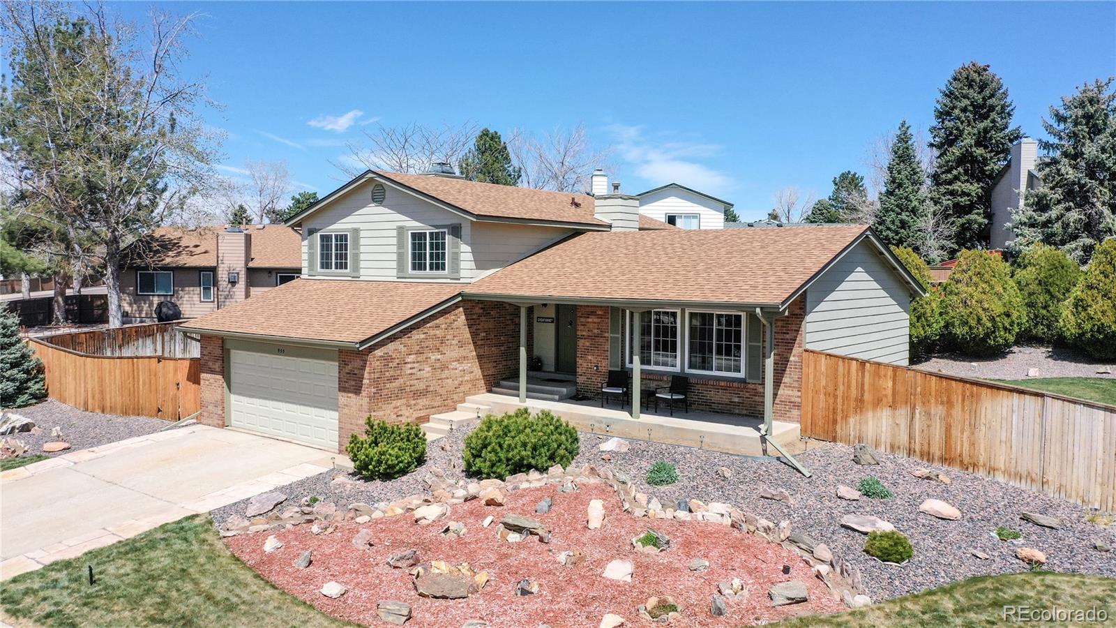 955 Northridge Road Highlands Ranch, CO 80126 - Photo 1 of 37 a front view of a house with a yard and garage