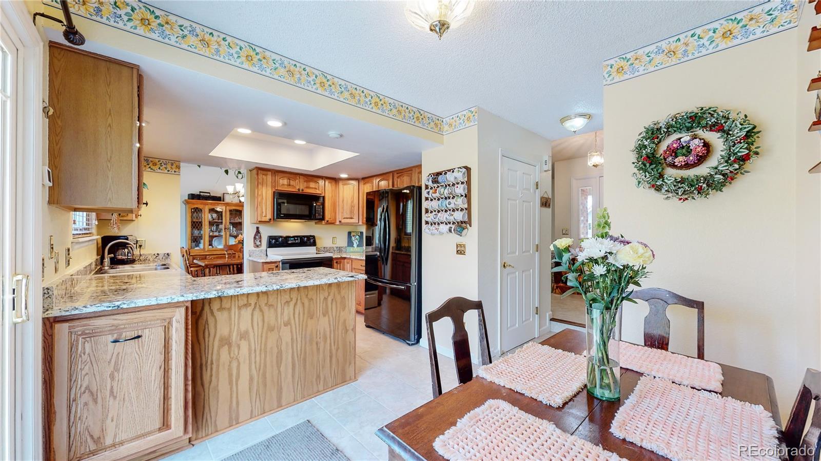 955 Northridge Road Highlands Ranch, CO 80126 - Photo 12 of 37 a kitchen with furniture and a refrigerator