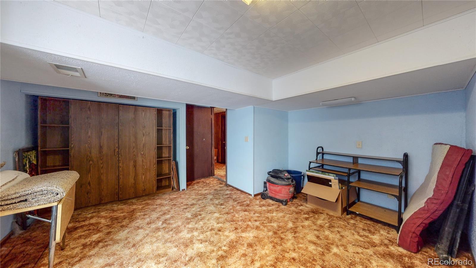 955 Northridge Road Highlands Ranch, CO 80126 - Photo 26 of 37 a bed room with a bed and a chair