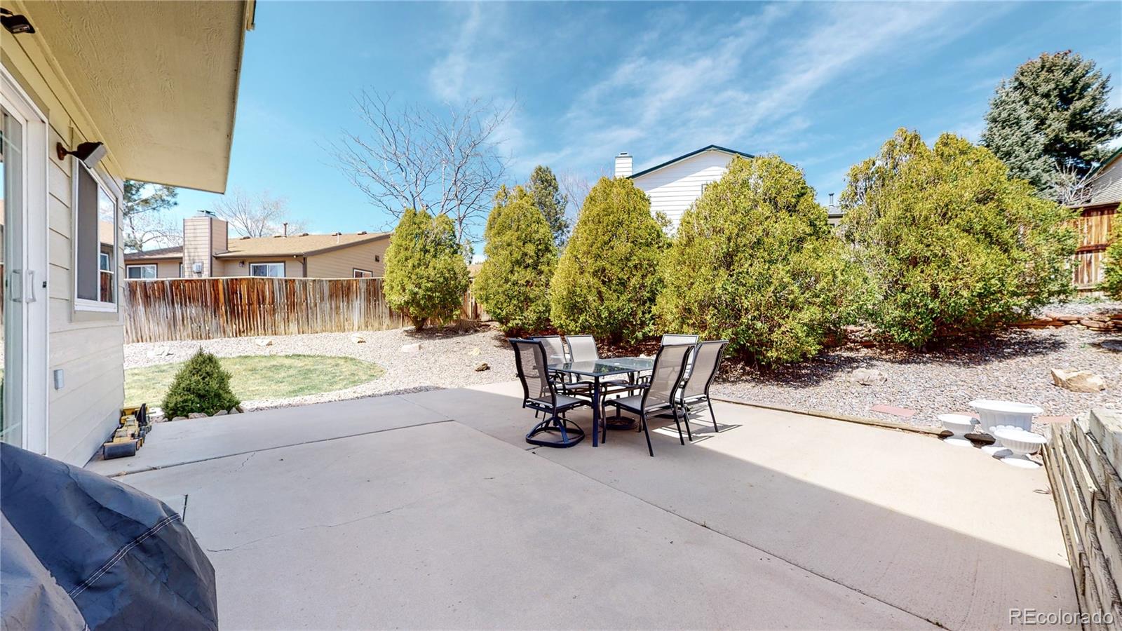 955 Northridge Road Highlands Ranch, CO 80126 - Photo 28 of 37 a view of a patio with a table and chairs and potted plants