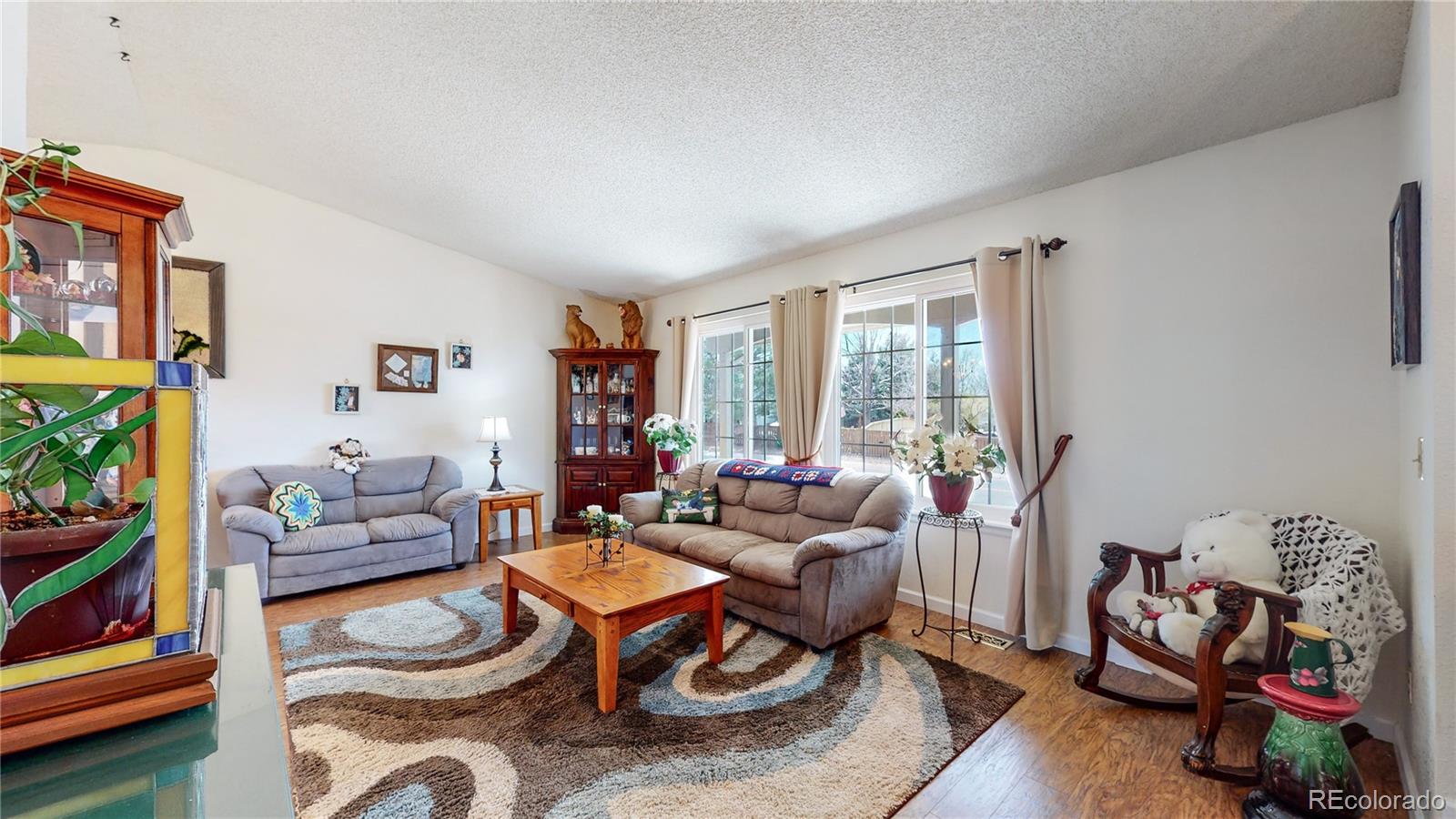 955 Northridge Road Highlands Ranch, CO 80126 - Photo 5 of 37 a living room with furniture and a floor to ceiling window