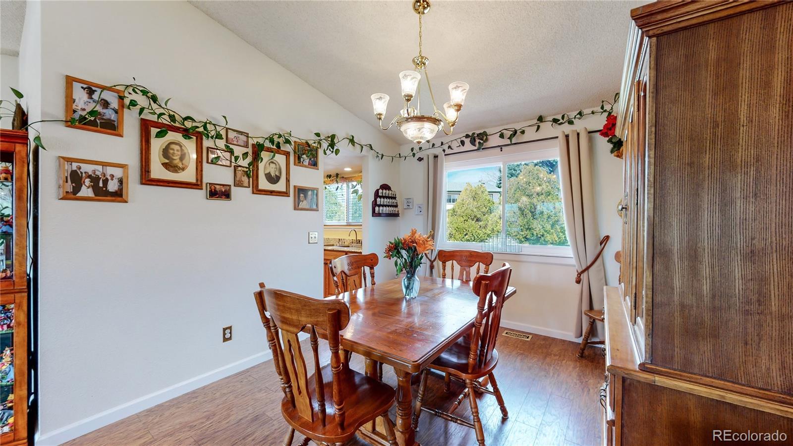 955 Northridge Road Highlands Ranch, CO 80126 - Photo 8 of 37 a view of a dining room with furniture window and wooden floor