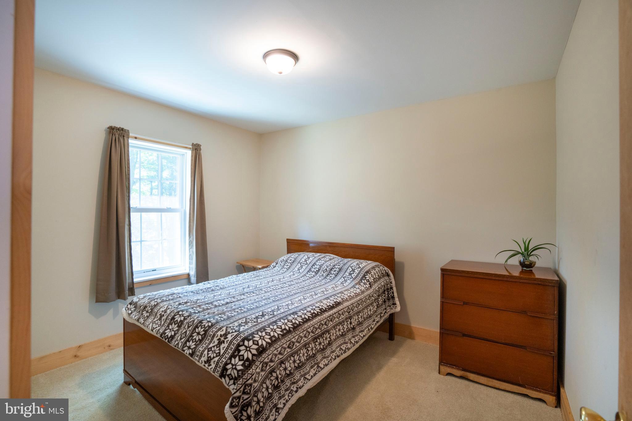 385 Elk Creek Road Aaronsburg, PA 16820 - Photo 50 of 71 a bedroom with a bed and a window
