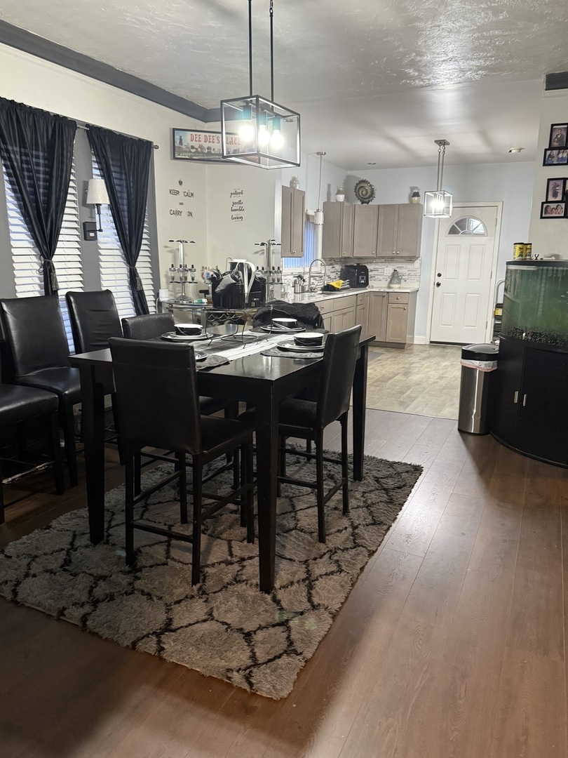 7825 South Paulina Street Chicago, IL 60620 - Photo 20 of 34 a large kitchen with a table and chairs