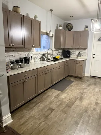 a kitchen with stainless steel appliances granite countertop a sink and cabinets