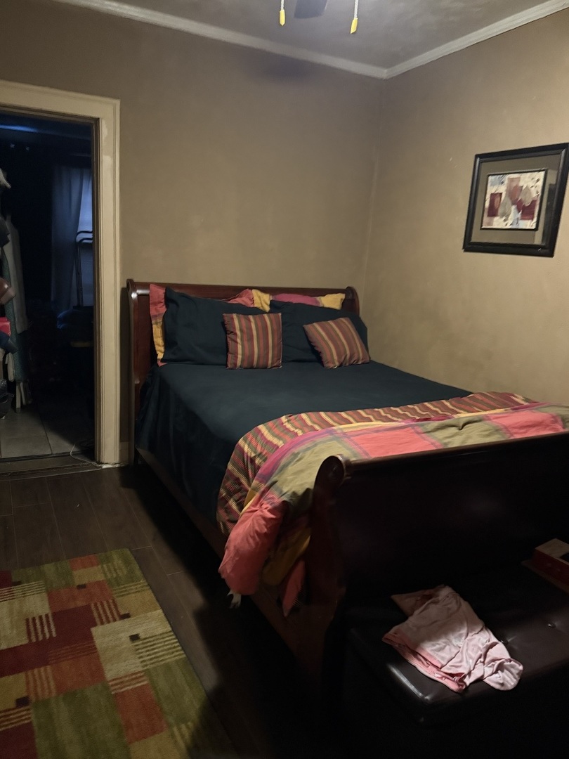 7825 South Paulina Street Chicago, IL 60620 - Photo 25 of 34 a bed sitting in a bedroom next to a window