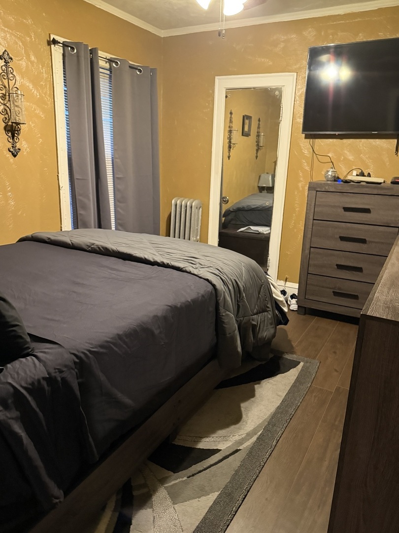 7825 South Paulina Street Chicago, IL 60620 - Photo 26 of 34 a bedroom with a bed and a mirror