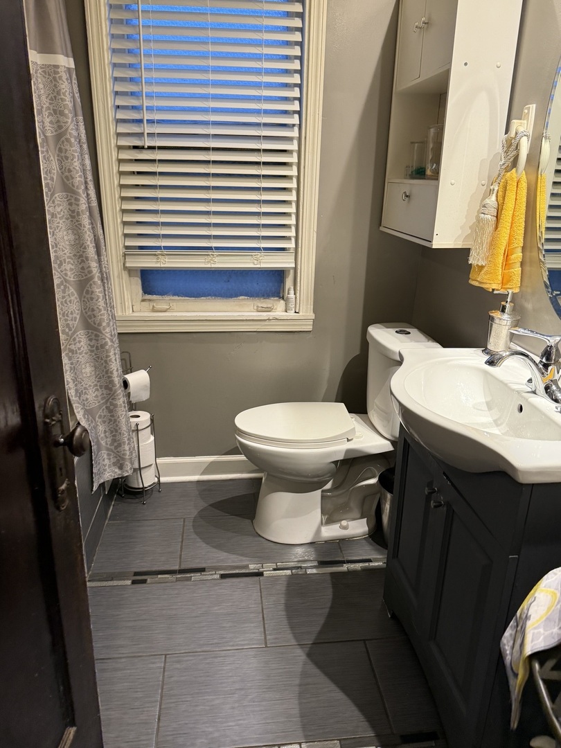 7825 South Paulina Street Chicago, IL 60620 - Photo 27 of 34 a bathroom with a sink toilet and mirror