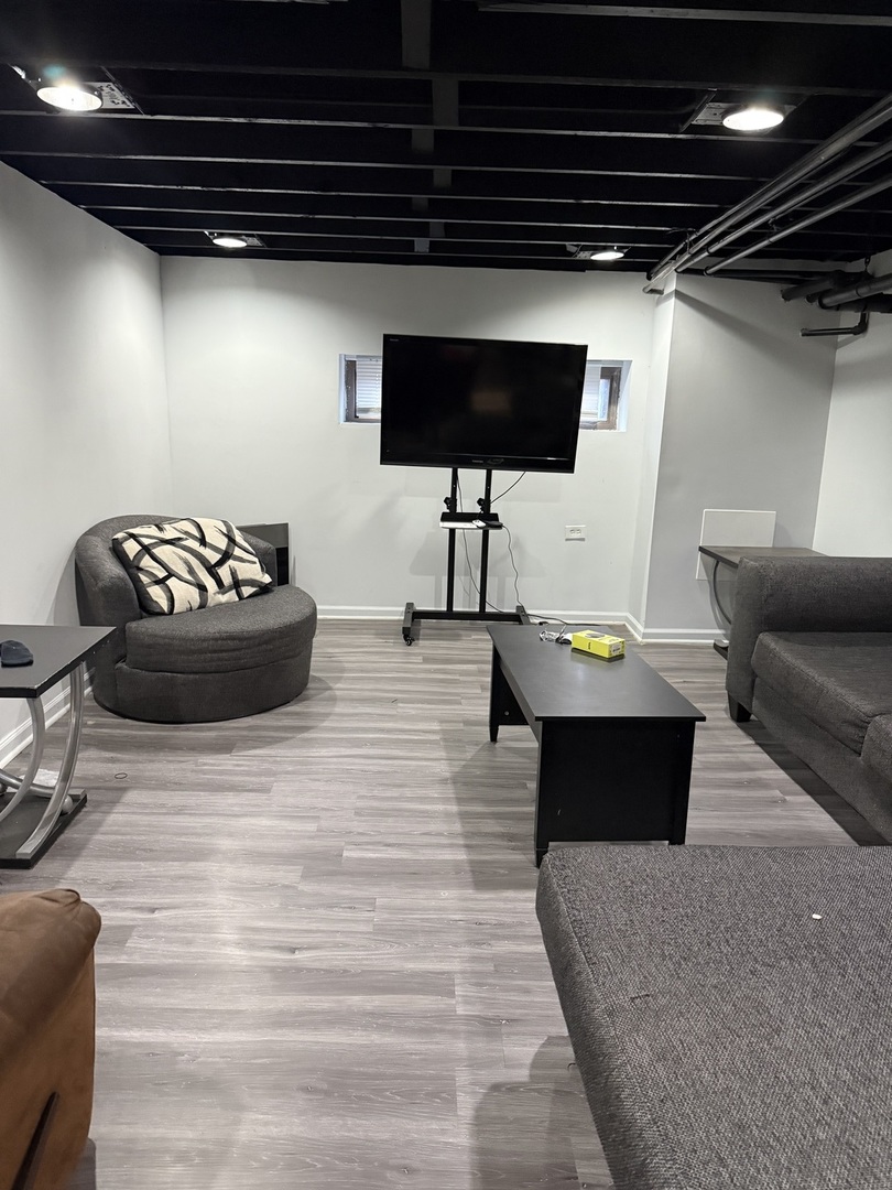 7825 South Paulina Street Chicago, IL 60620 - Photo 30 of 34 a living room with furniture and a flat screen tv