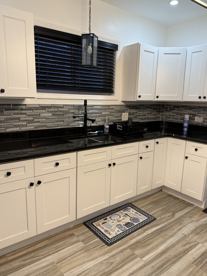 7825 South Paulina Street Chicago, IL 60620 - Photo 5 of 34 a kitchen with granite countertop a sink and white cabinets