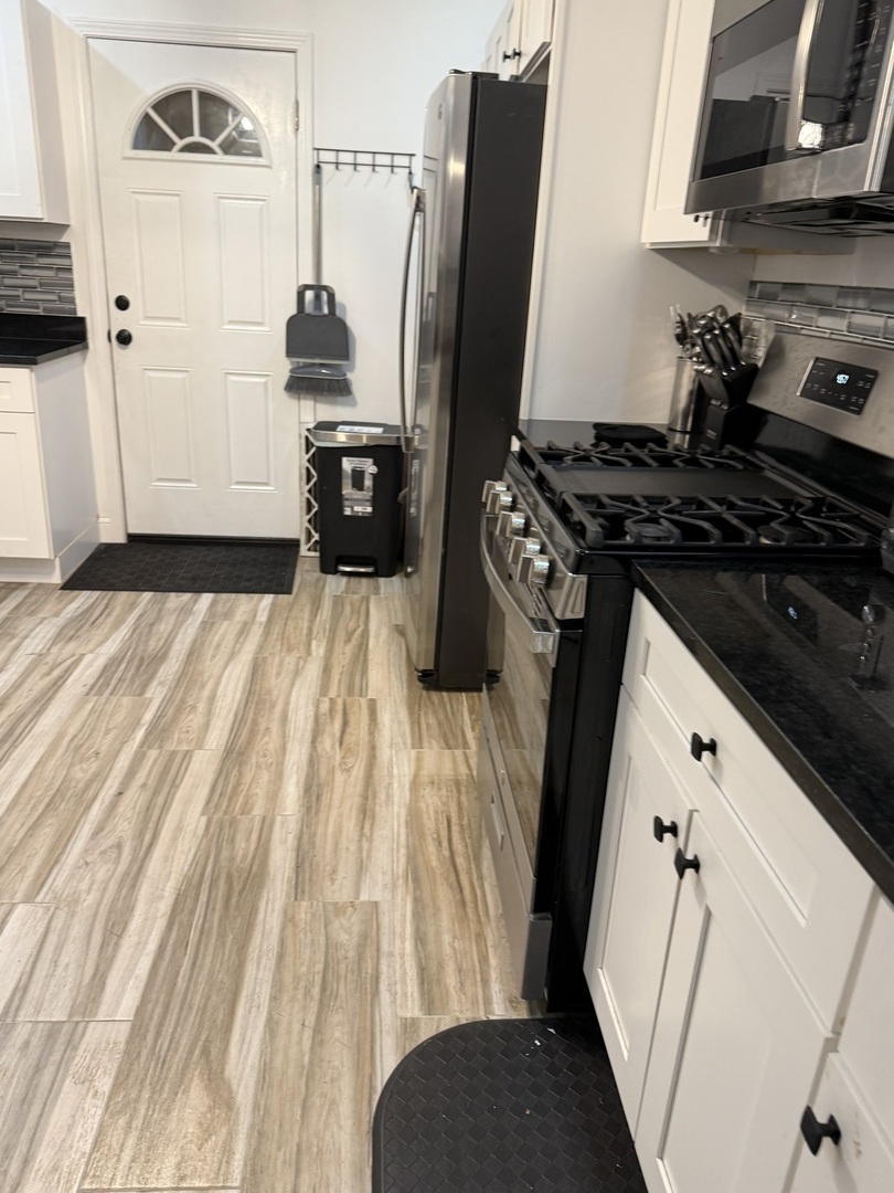 7825 South Paulina Street Chicago, IL 60620 - Photo 8 of 34 a kitchen with a sink stove and refrigerator