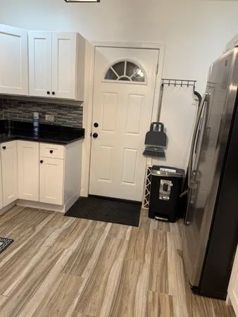 a view of a closet area with furniture and wooden floor