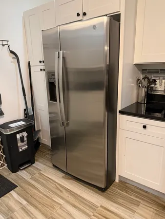 a kitchen with a refrigerator and a stove