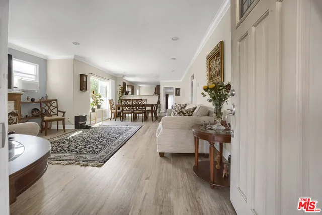 a living room with furniture and a dining table