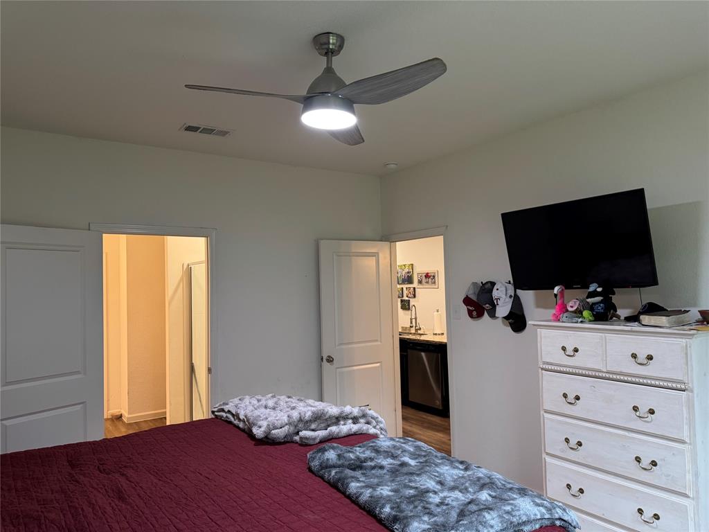 2209 Cinnamon Spgs Road Glenn Heights, TX 75154 - Photo 9 of 28 White walls featuring a ceiling fan with integrated lighting