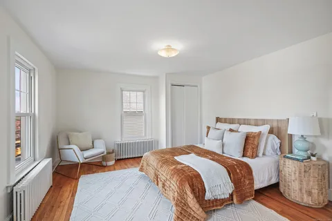 a bedroom with a bed and window